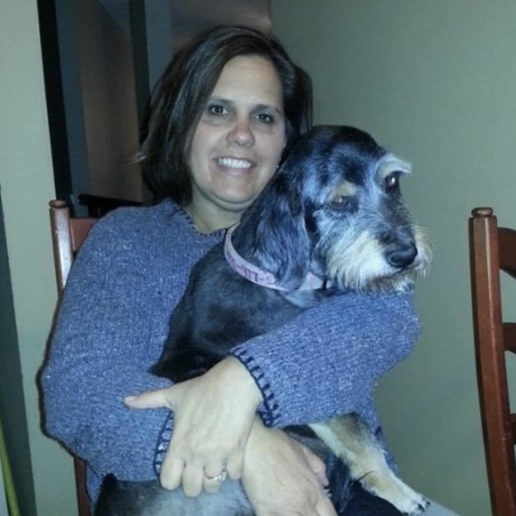 Mackenzie the dog being held by her owner